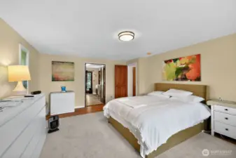 Retreat to the spacious master suite, where large windows capture the beauty of the morning light.