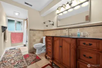 The master suite is complemented by a spacious spa-inspired bathroom featuring rich wood cabinetry, granite countertops, an oversized linen closet, a jetted soaking tub, and a separate shower.”