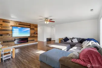 Large living room with a custom accent wall with fireplace - Yes, the new 75" TV and sound bar are included!