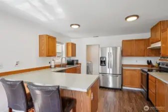 Space for multiple cooks in the kitchen! Dual pupose utility room and walk-in pantry off the kitchen too!