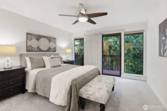 A sliding door leads to a private balcony with views of the towering evergreens.