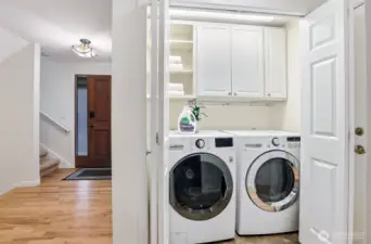 Laundry closet on the main floor in the hallway leading to the garage door.