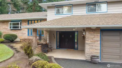 Upon arrival, the architectural composition roof immediately stands out, complemented by the meticulously maintained grounds and exterior of the home.
