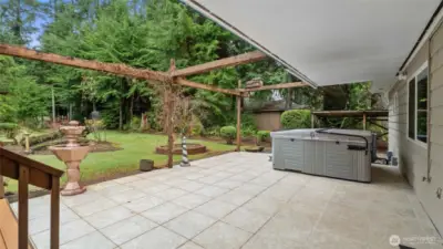 Nice patio partially covered with hot tub to relax in.