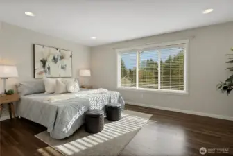 Primary Bedroom with laminate hardwood flooring.