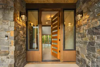 Inside, wood and stone accents seamlessly integrate with the natural surroundings, creating a harmonious blend of contemporary design and rustic charm.