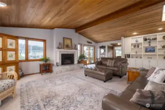 Open light filled living room with a view to canal. Gorgeous cedar ceilings