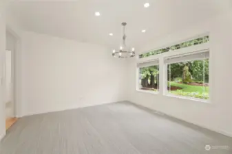 Formal Dining Room  Carpeted / Recessed lighting with gorgeous chandelier  Window wall overlooking front yard.   Access from entry as well as hallway by kitchen