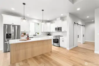 The hallway on the right leads to office, front entrance, two bedrooms and a full bathroom.