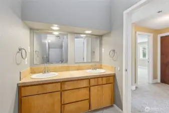 Unit B’s upstairs 3/4 bathroom combines style and privacy in all the right ways. Vaulted ceilings and high windows flood the space with natural light while keeping things private. The long vanity with dual sinks gives you plenty of space, and the tile shower with a glass door adds an extra touch of elegance. Plus, the toilet is tucked behind the shower for added privacy too!