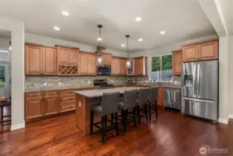 Gourmet kitchen with bar seating and granite countertops.