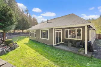 Covered patio out back to enjoy the outdoors in any weather.
