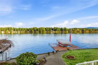 Private deep-water dock with boat well and expansive lake views.