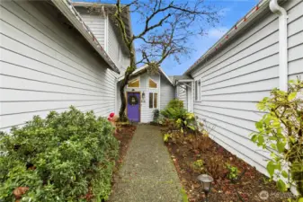 Charming garden walkway guiding you to the front door.