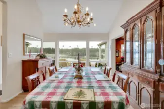 Elegant dining room with ample space for entertaining and view of the water