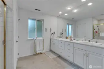Spacious main bedroom bathroom with dual vanity, walk-in shower, and abundant storage