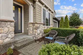Covered entry with a relaxing front patio - perfect for catching up with friends and neighbors