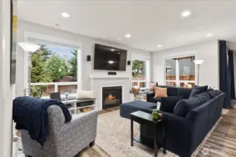 Enjoy watching TV or relaxing in front of the fire in the living room. Custom built-in's under the window are just one of the upgrades you will find in the home.