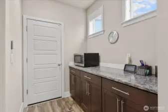 The butlers panty offers you extra storage and counter space just off the kitchen. And through the door, you will find the finished garage space.