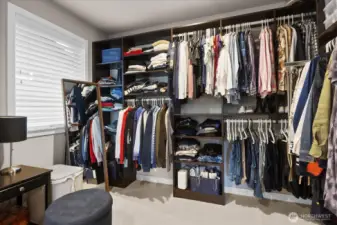This walk-in closet was desigend by the seller with a custom organizer and adds a unique bonus closet to the primary suite.