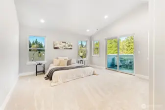 Upstairs Primary Suite features an outdoor balcony, so much natural light, vaulted ceilings, complete with a huge walk-in closet, and primary bathroom.