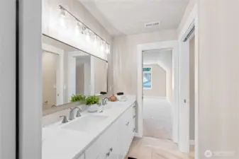 This Jack and Jill bathroom is share between bedrooms #3 and #4, long double sink vanity, with pocket doors on each bedroom for privacy, titled flooring, under cabinet lighting, and a separate toilet and shower room!