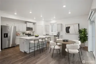 Large kitchen with informal dining area that doubles as open office space or breakfast nook. Photo is representational. Actual home is under construction. Colors, materials, and features may vary. See site agent for details.