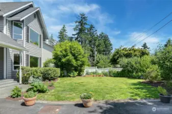 Large front yard with mature shrubs sets the home back nicely from the quiet street.