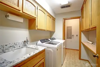 Large laundry room with utility sink.
