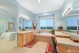 Primary bath with separate vanities and a soaking tub.
