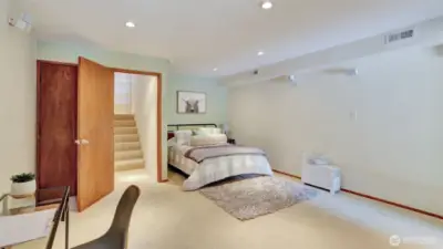 This guest room features soft carpeting and a cozy, welcoming feel.
