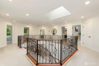 Upon exiting the primary suite, you'll enter the circular hallway with sightlines to the other three bedrooms, bonus room, to bathrooms, and laundry. Such a unique layout that brings in so much light.