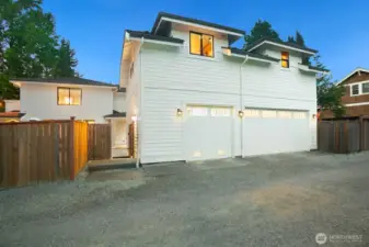 The detached garage with DADU above (looking from the alley). The far left garage is separate from the other two and is dedicated to the DADU, if necessary. The larger garage door is a two-car garage for the main house. You enter by the covered patio off the kitchen (or mudroom). The gate to the left here is a double-wide for ease of moving things inside and out! The DADU entrance is just before the gate pictured here.