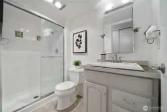 Step into the primary bathroom with stylish designer tile adorning the shower for a luxurious feel.