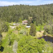 Aerial overview of the property shows the pond location in relationship to the home