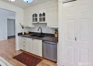 Efficient galley kitchen with pantry. Virtually staged.