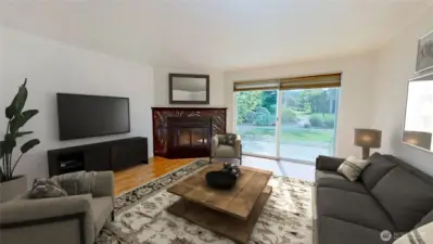 Living room with wood fireplace and slider to the garden patio. Virtually staged.