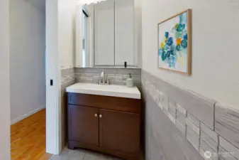 Main level half bath. Virtually staged.