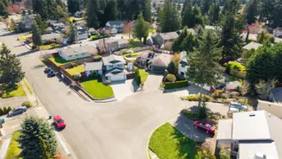 Ariel view of home on corner lot on cut-de-sac.
