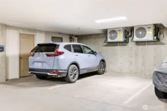 Two secure parking spots with a storage room to the left.
