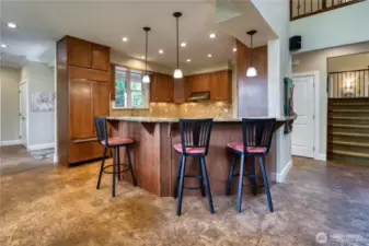 View of the Chef's kitchen with maple cabinetry, granite counters and Wolf Appliances.