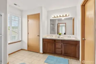 Primary bath, double sink, linen closet to the left