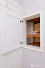 Convenient pass-through from hall storage to bathroom. Love it!