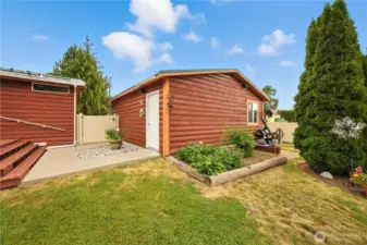 The detached garage is just a few steps away and the seasonal garden is well on its way to producting.
