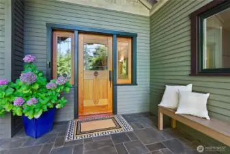 This generous covered porch and Artisan Cherry Front Door welcome you!