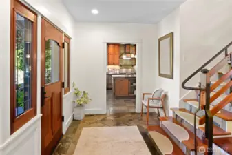 Once inside you'll love the custom built stairway and iron work. Warm slate floors.