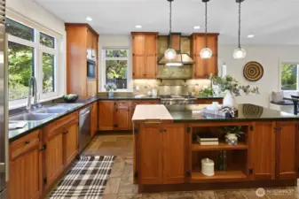 Luxurious chef's kitchen features custom cherry cabinetry and granite countertops.