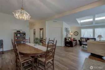 Notice warm wood LVP floors and lots of light!