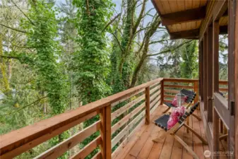 The deck off the living room allows you to enjoy the tranquil wooded and peek-a-boo mountain views.