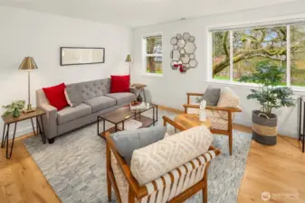 The home enters to this sweet living room with hardwood floors and nice light.